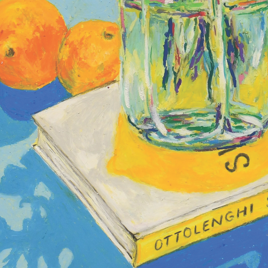Close up of oil pastel Ottolenghi book, vase and oranges