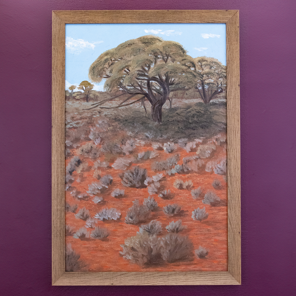 Way Out In Whyalla painting, photographed on a purple wall.