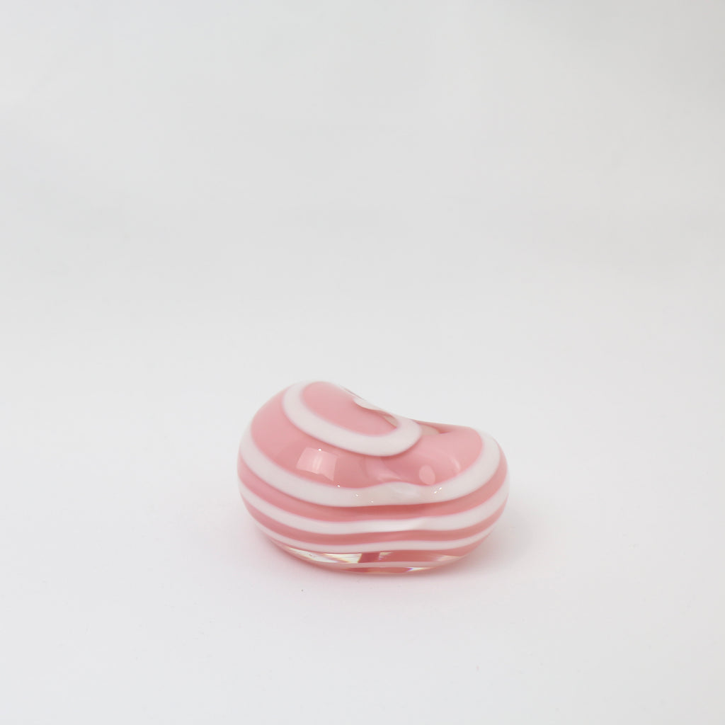 A little glass keepsake that will brighten up any desk, coffee table, or bookshelf. It is pink with a white swirl.