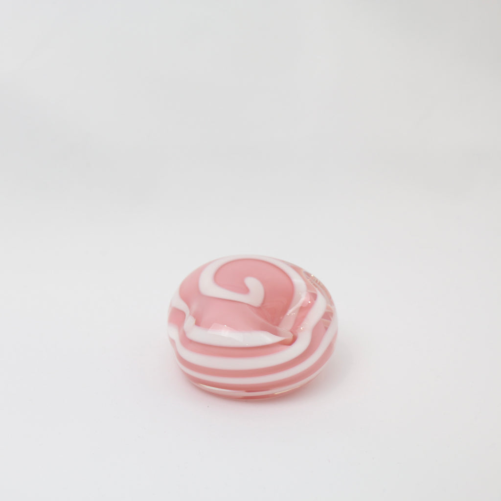 A little glass keepsake that will brighten up any desk, coffee table, or bookshelf. It is pink with a white swirl.