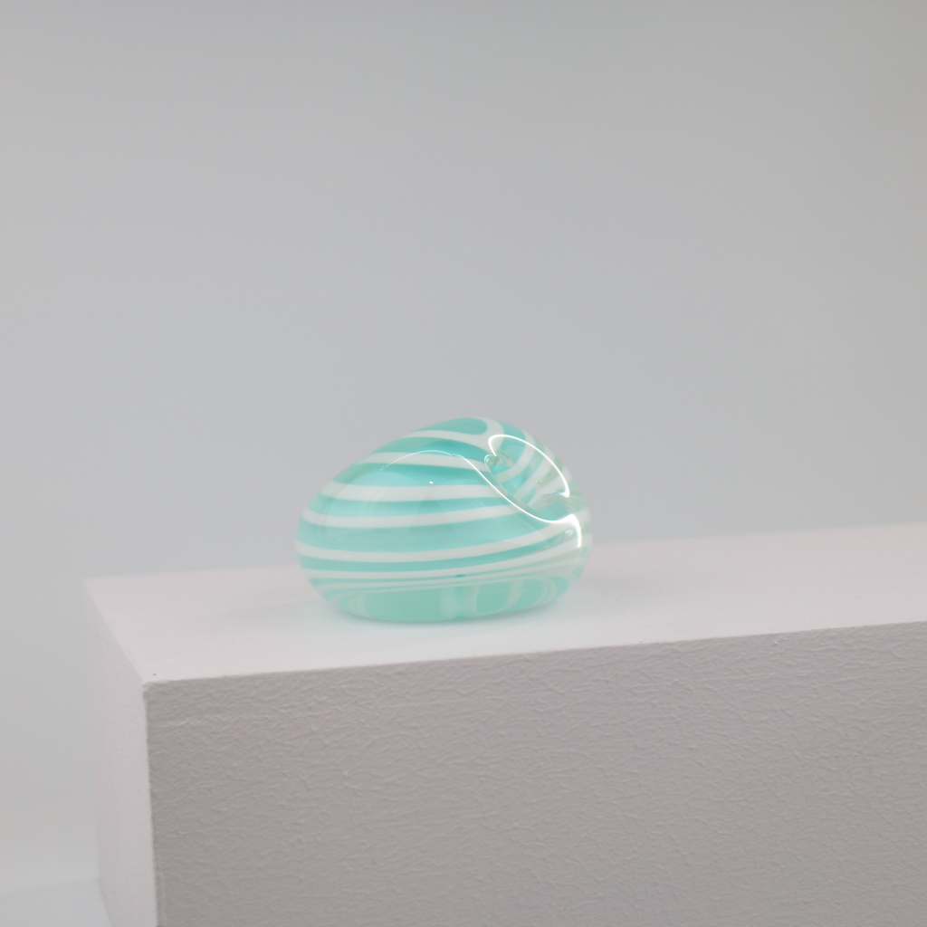 A little glass keepsake that will brighten up any desk, coffee table, or bookshelf.  It is blue with a white swirl.